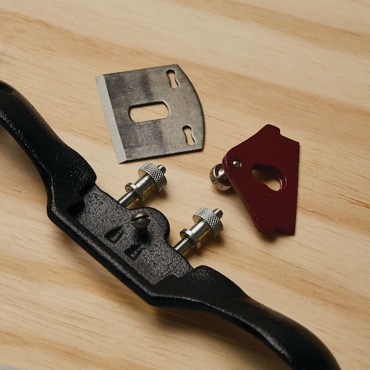 STANLEY 12-951 spokeshave and parts, including black metal body, blade, and red adjustment knob on wood surface.