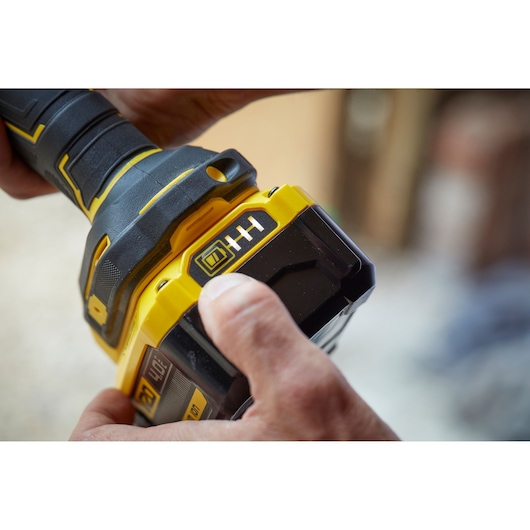 STANLEY SCG400M2K-KR cordless tool close-up showing yellow and black battery pack being held.