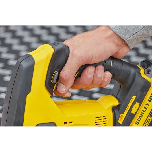 Photo of STANLEY SCJ600B jigsaw handle in use, showing yellow and black ergonomic grip.
