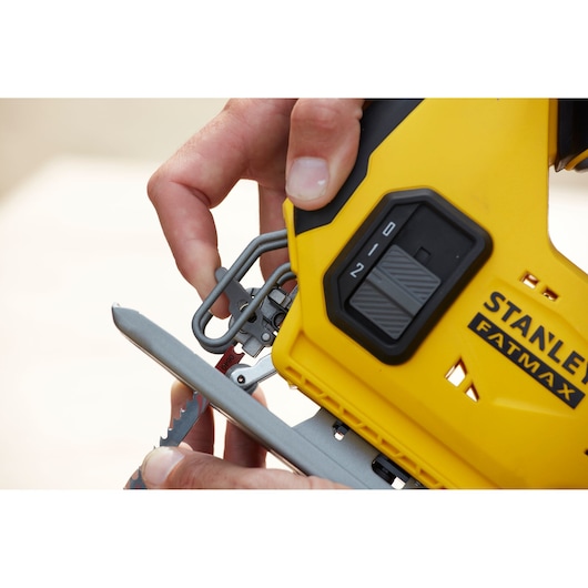 Stanley SCJ600B jigsaw close-up showing blade change feature, yellow housing, FATMAX branding.