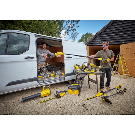 STANLEY SCV002 photography of outdoor scene with yellow power tools near a white van and wooden shed.