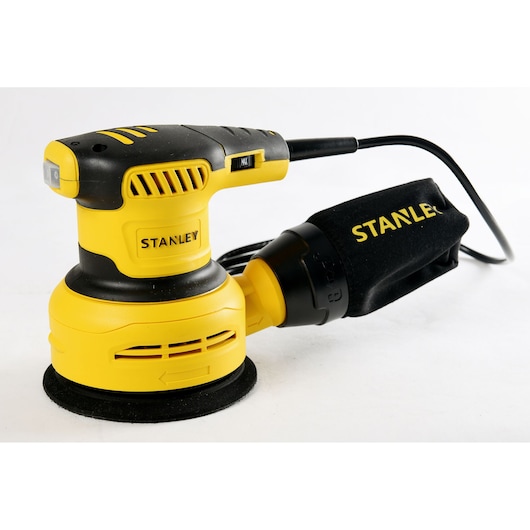 Stanley SS30-B2C yellow and black random orbital sander, side angle, with dust bag, on white background.