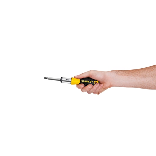 Photo of STANLEY STHT54925-840 screwdriver with black and yellow handle held in hand, side angle.
