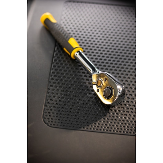 Photo of STANLEY STMT82665-0 ratchet wrench with yellow and black handle on perforated mat.