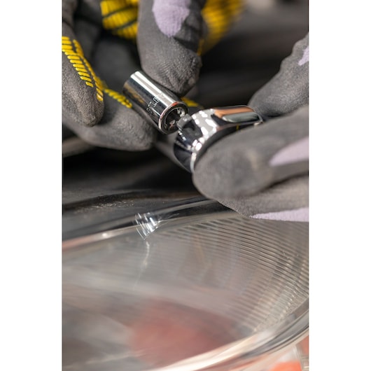STANLEY STMT82829-1 socket being attached to a ratchet, close-up of gloved hands, product photography.