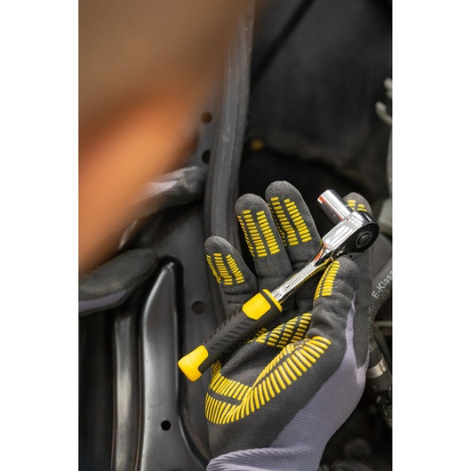 Photo of STANLEY STMT82829-1 ratchet wrench held in a gloved hand, featuring a black and yellow handle.