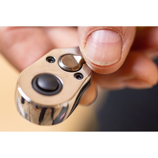 Close-up photo of a hand using a STANLEY STMT82829-1 ratchet wrench showing the switch mechanism.