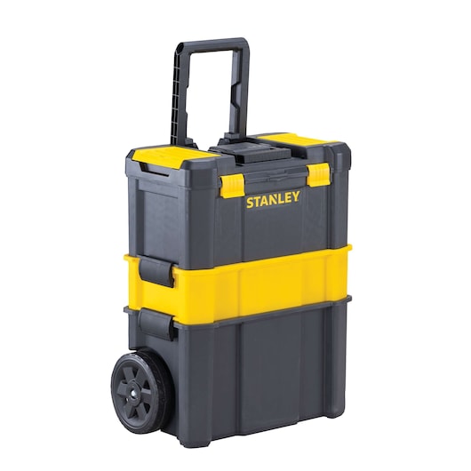 Front angle of Stanley rolling tool chest, black and yellow, with telescopic handle and two wheels.