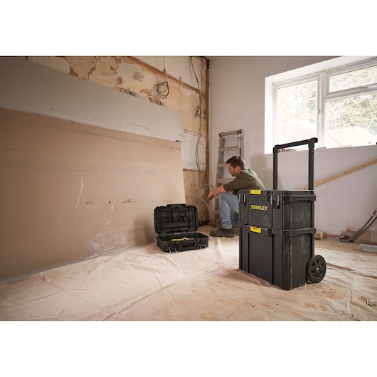 Stanley STST83319-1 rolling toolbox in a renovation setting with open tool case, photo of product in use.