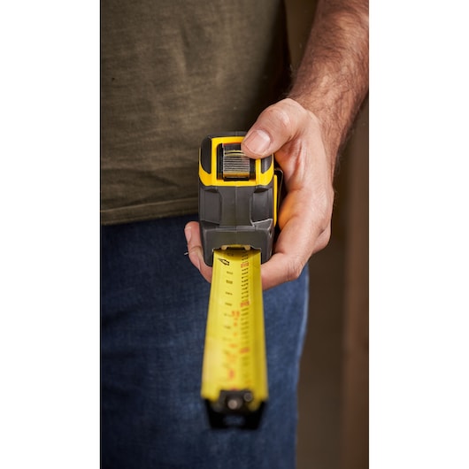 STANLEY XTHT0-33504 tape measure photography, front view, yellow and black casing, extended blade.
